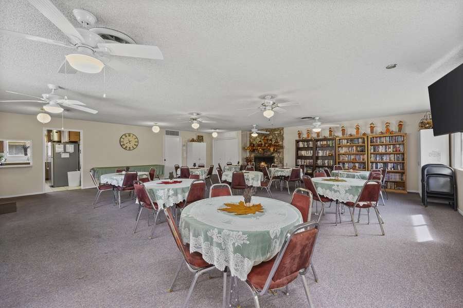 Screened garden patio with red chairs
